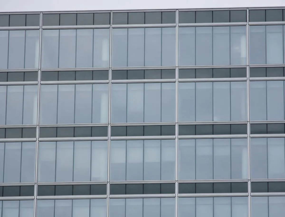American mid-rise commercial curtain wall with aluminum pressure plate grid and spandrel bands